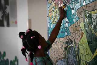 Girl with mural in University Hospital